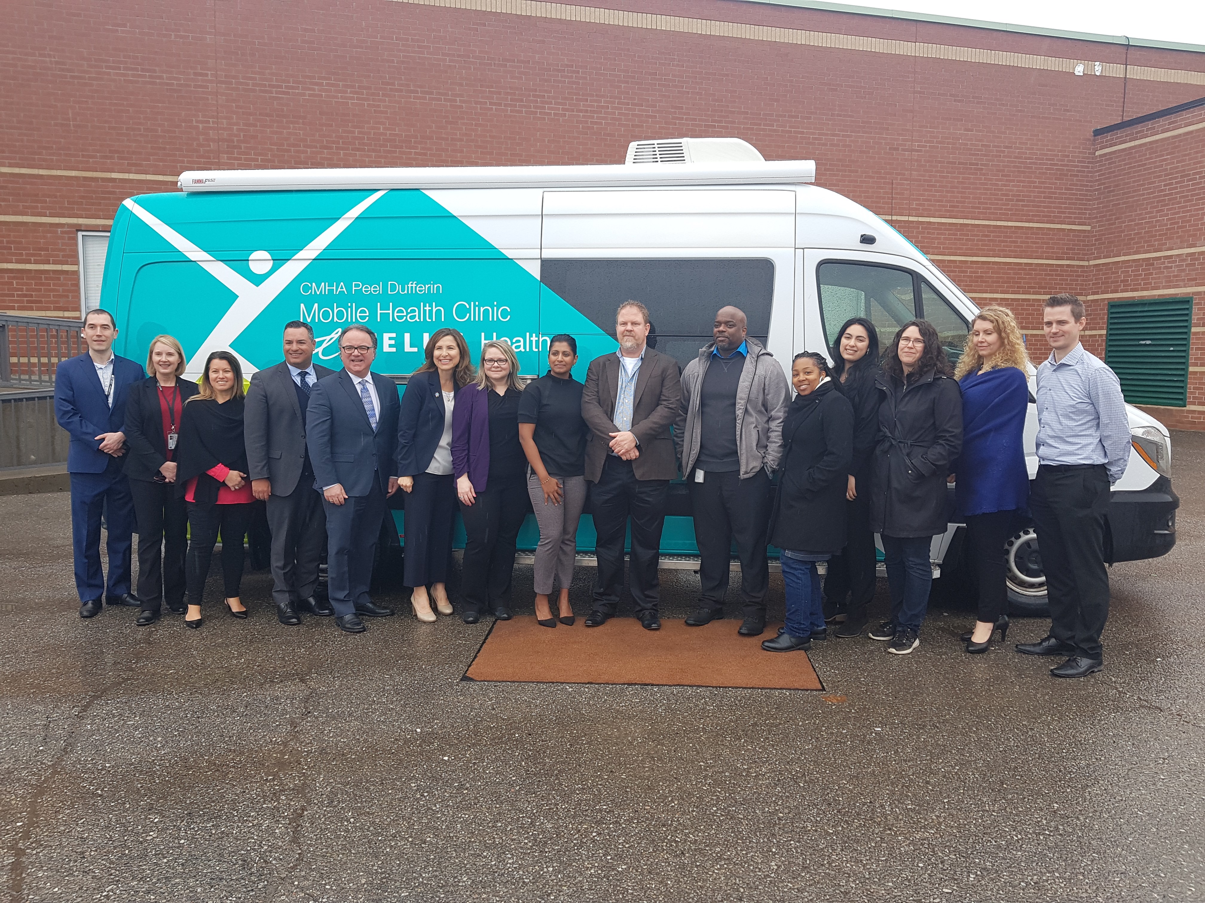 CMHA Team standing infront of the Mobile Health Clinic powered by TELUS
